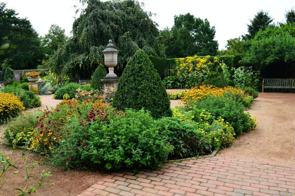 Formal garden with stone urn.